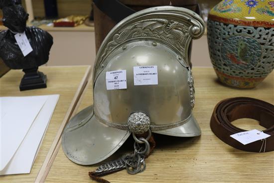A firemans helmet and a leather belt